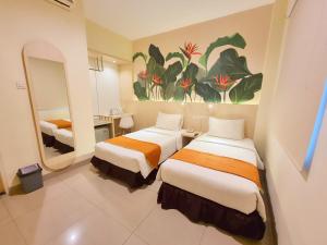 Postel nebo postele na pokoji v ubytování D'Bamboo Suites