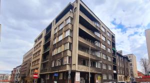 a tall building on the corner of a street at Hostel Moderna Rest in Katowice