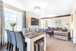 a living room with a table and chairs and a couch at Bridge House in Totnes