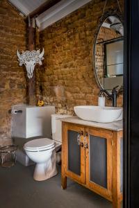 a bathroom with a toilet and a sink and a mirror at 1 Queen Vic in Darling +20 photos