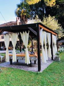 een tafel met witte gordijnen in het gras bij Villa Berghella in Montesilvano