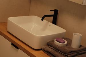 a white sink sitting on a counter with a towel at Crystal Studio in Kutná Hora