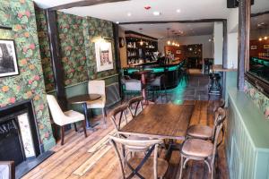 a restaurant with tables and chairs and a bar at The Crown Hotel in Glastonbury
