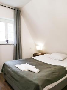 a bedroom with two beds and a window at ✰Mansarda na Białoskórniczej✰5 minut od Rynku in Wrocław