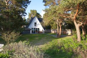 a white house in the middle of a yard at Ferienhaus-Achterwasser-Usedom in Rankwitz