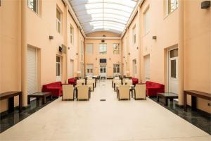 un couloir avec des tables et des chaises dans un bâtiment dans l'établissement Residencia Universitaria Micampus, à Aranjuez