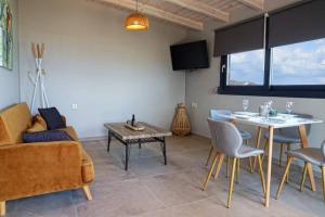 a living room with a couch and a table at Havana 2 Luxury sea and pool in Gázion