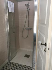 a bathroom with a shower with a glass door at Overvoll Farm in Stranda