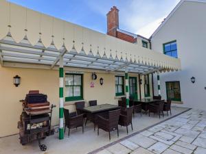 a patio with a table and chairs under awning at Railway Hotel in Fordingbridge