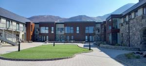 a group of buildings with a lawn in front of it at Murrisk Apartments - Self Catering in Westport