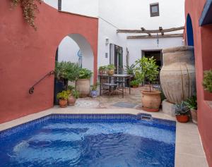 a swimming pool in the middle of a house at Casa Aire de Lecrin in Pinos del Valle