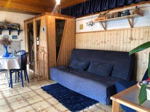a living room with a blue couch and a table at Jorgos Apartman in Keszthely