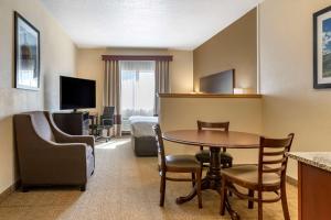 a hotel room with a table and a bed at Comfort Inn & Suites in Paw Paw