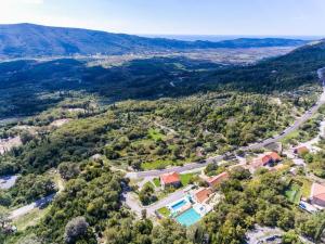 an aerial view of a house with a swimming pool and a road at Villa Falcon Rook in Gruda