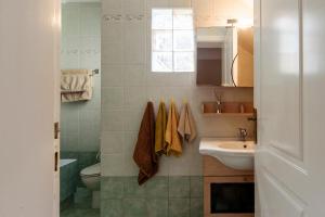 a bathroom with a sink and a toilet at JASMINE OF POSEIDONIA in Posidhonía