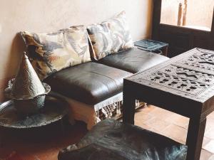 un soggiorno con divano in pelle e tavolo di Dar Blues a Boumalne Dades