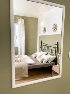 a bedroom with a bed in a mirror at Rooms Lucia in Split