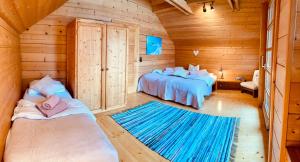 a room with two beds in a log cabin at Haus Liesenfeld in Gosau