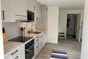 a kitchen with white cabinets and a sink at Naturnära boende i vackra Järvsö - H in Järvsö