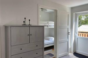 a white dresser in a room with a mirror at Naturnära boende i vackra Järvsö - H in Järvsö