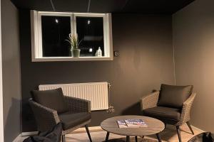 a room with two chairs and a table and a window at Naturnära boende i vackra Järvsö - H in Järvsö
