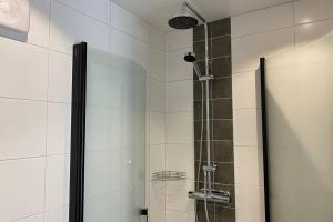 a shower with a glass door in a bathroom at Naturnära boende i vackra Järvsö - H in Järvsö