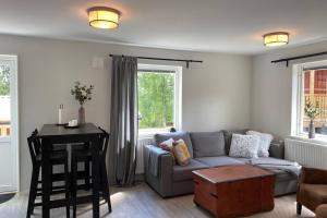 a living room with a couch and a table at Naturnära boende i vackra Järvsö - H in Järvsö