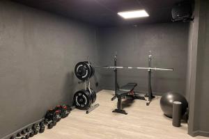 a room with a gym with a treadmill and weights at Naturnära boende i vackra Järvsö - H in Järvsö
