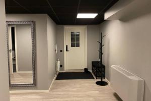a hallway with a white door and a mirror at Naturnära boende i vackra Järvsö - H in Järvsö