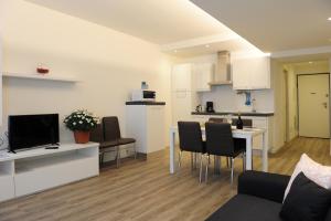 a living room with a kitchen and a dining room at RivAppartamenti in Riva del Garda