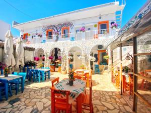 a restaurant with tables and chairs in front of a building at Bodrum Sade Pension in Bodrum City