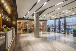 a lobby with a view of a car dealership at Aber Unayzah in Unayzah