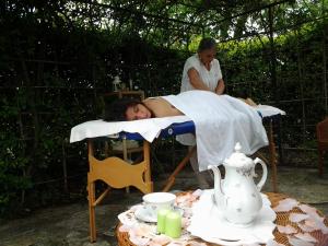 a woman laying in a bed with a woman standing behind at Agriturismo Villa Vetiche in Rocca San Giovanni