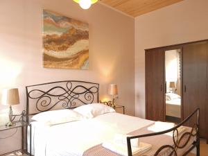 a bedroom with a bed and a painting on the wall at On the water lodging 1 in Falasarna