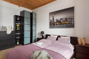 Un dormitorio con una cama morada y una foto en la pared en Apartament Bystre, en Zakopane