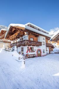 a building with snow on the ground in front of it at Haus Erbhof in Sölden