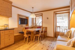 a kitchen with a table and chairs in a room at Cadin Apartment in Cortina dʼAmpezzo