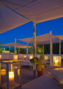 a tent with candles and a table with a plant at Masseria Cimino in Savelletri di Fasano