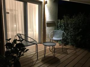 two chairs and a table on a wooden deck at Prea Gianca in Bonifacio