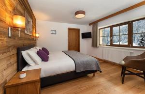 a bedroom with a bed and a desk and a chair at Haus Gertrud in Sankt Anton am Arlberg