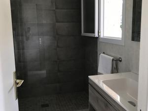 a bathroom with a shower and a white sink at Prea Gianca in Bonifacio +35 photos