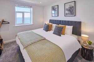 a bedroom with a large white bed with a window at Host & Stay - The Waves in Whitby