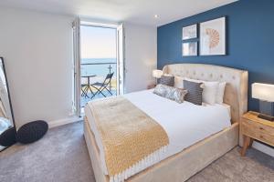 a bedroom with a bed and a view of the ocean at Host & Stay - The Waves in Whitby