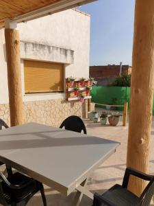 a white table and chairs on a patio at Casa Pepe de L´ullat in Deltebre