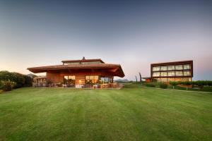 a large house with a large lawn in front of it at Empordà Golf Resort in Torroella de Montgrí