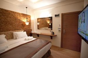 a hotel room with a bed and a tv at Pera Line Hotel in Istanbul