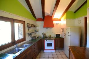 a kitchen with a sink and a white refrigerator at CASA TERESA in Albanya