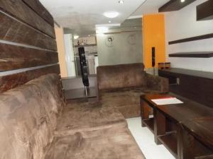 a living room with a couch and a table at Prixair Hotel Limited in Abuja