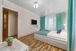 A bed or beds in a room at Apartment Hanaka Volgogradskiy