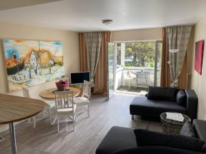 a living room with a couch and a table at ART-hüs in Westerland